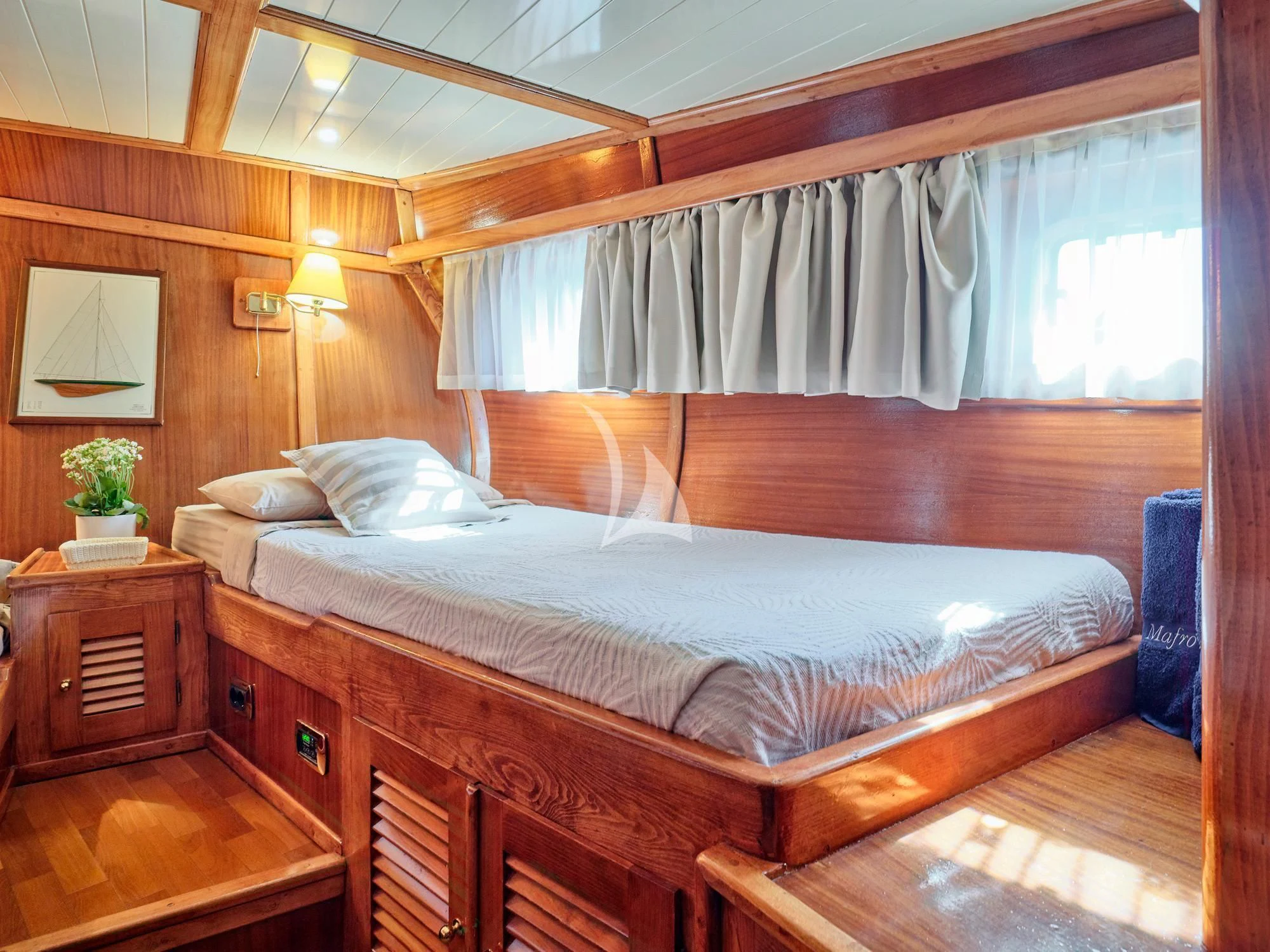 a bed with a wooden headboard aboard MYRA Yacht for Sale