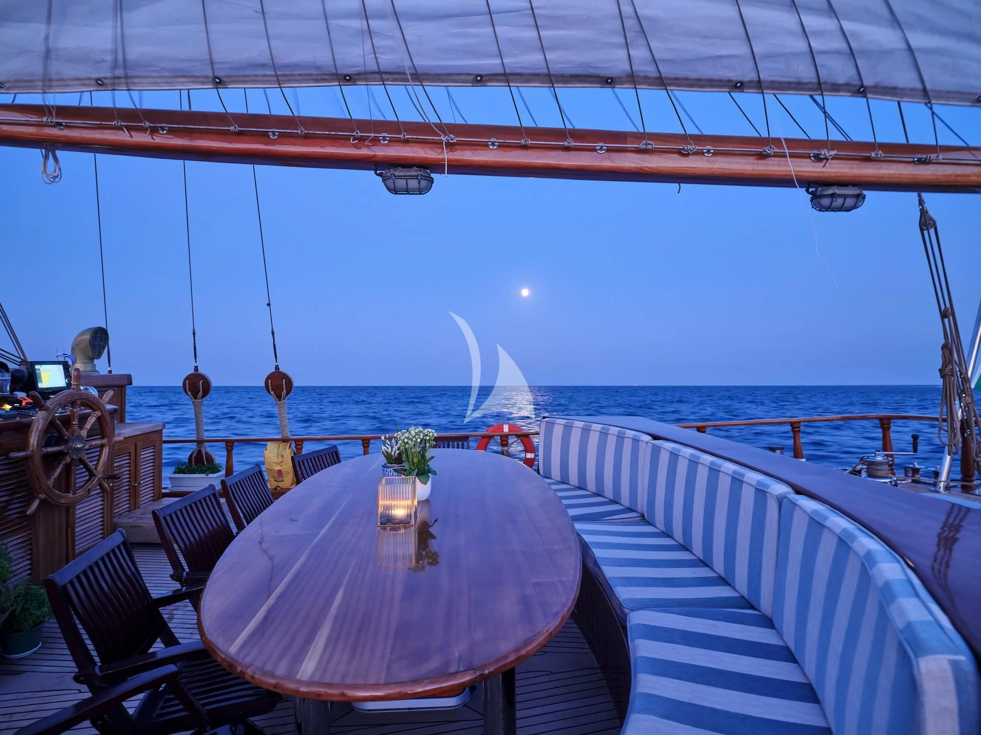 a table on a deck overlooking the ocean aboard MYRA Yacht for Sale