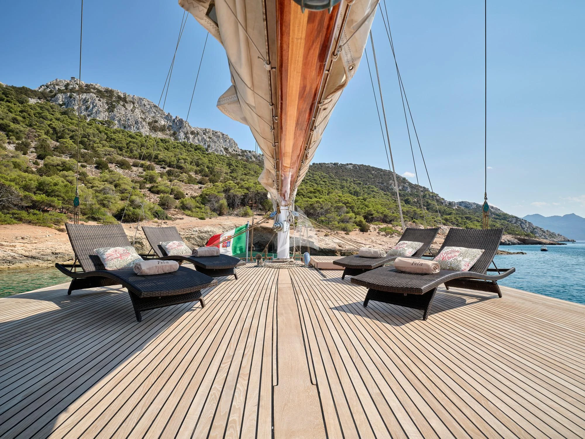 a deck with chairs and a hammock on it aboard MYRA Yacht for Sale