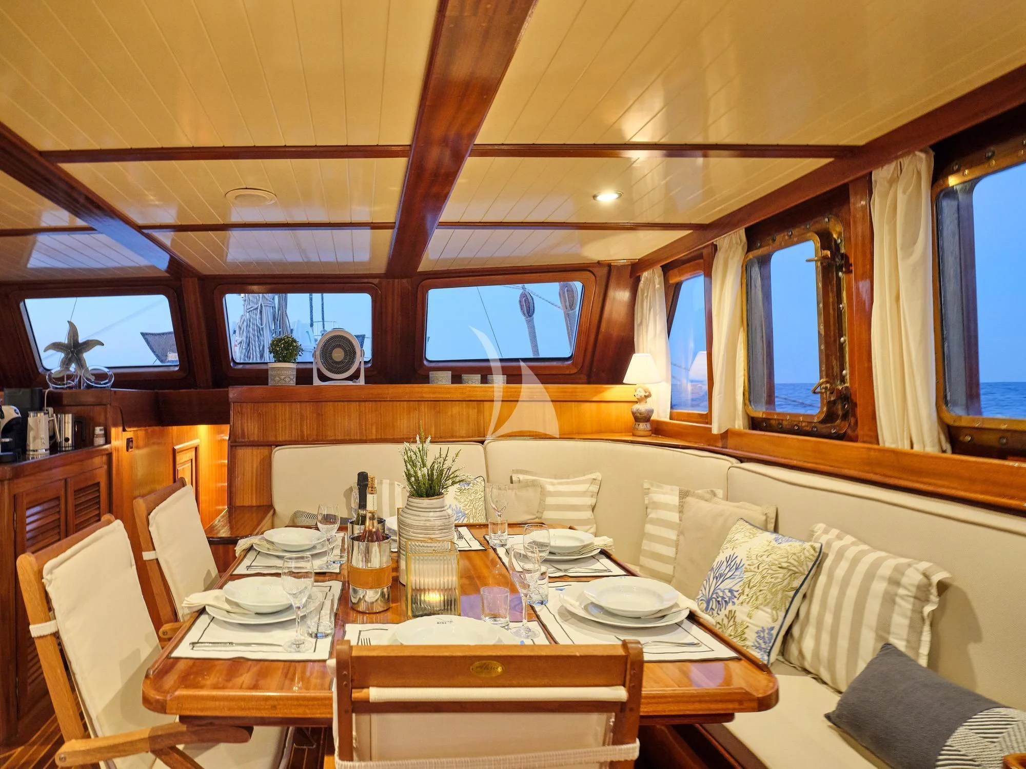 a dining table with plates and chairs aboard MYRA Yacht for Sale