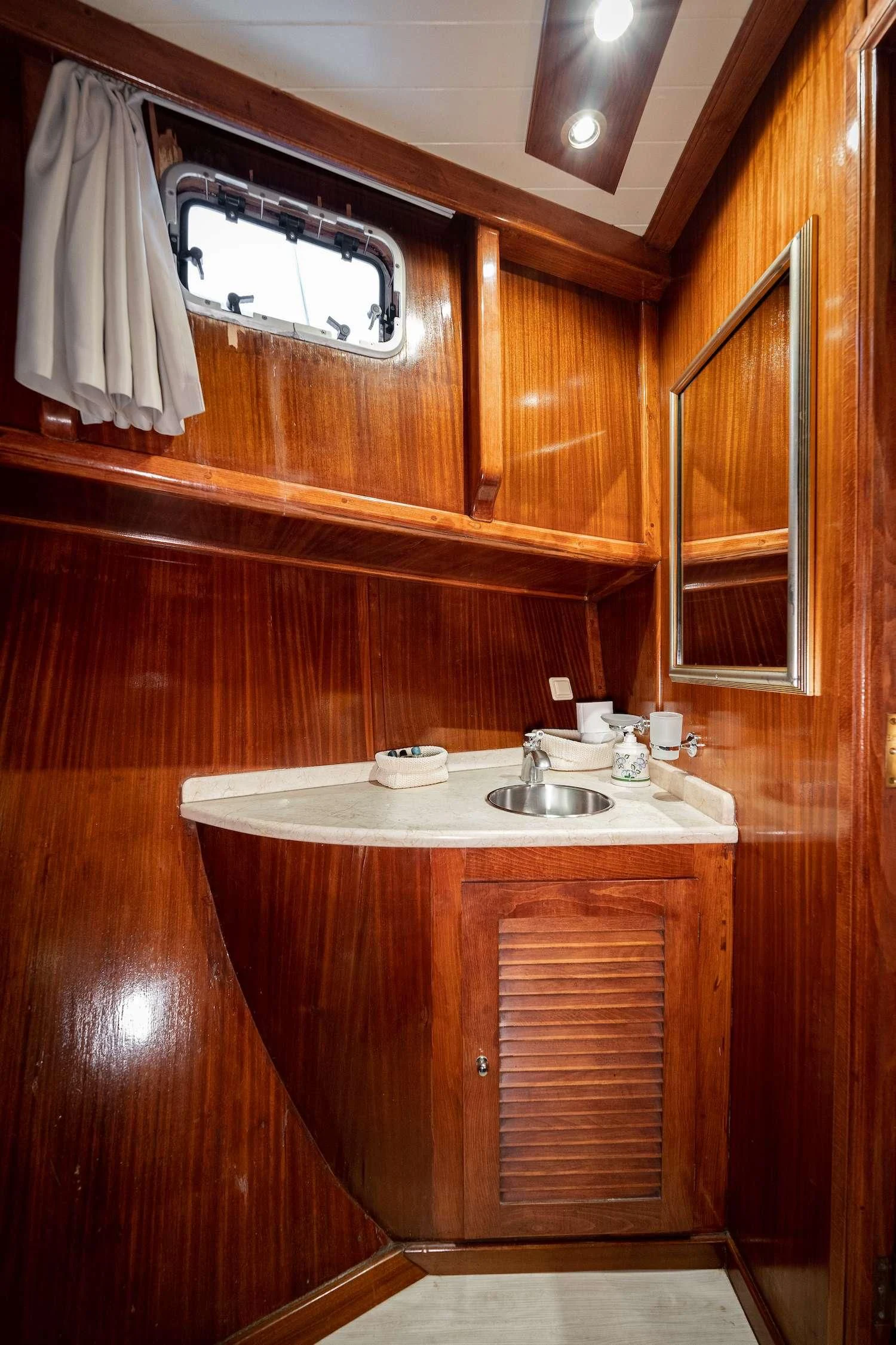 a bathroom with wooden cabinets aboard MYRA Yacht for Sale