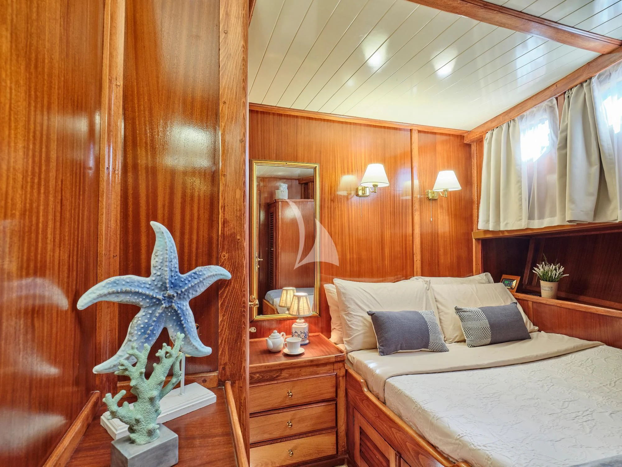 a bedroom with a large mirror aboard MYRA Yacht for Sale