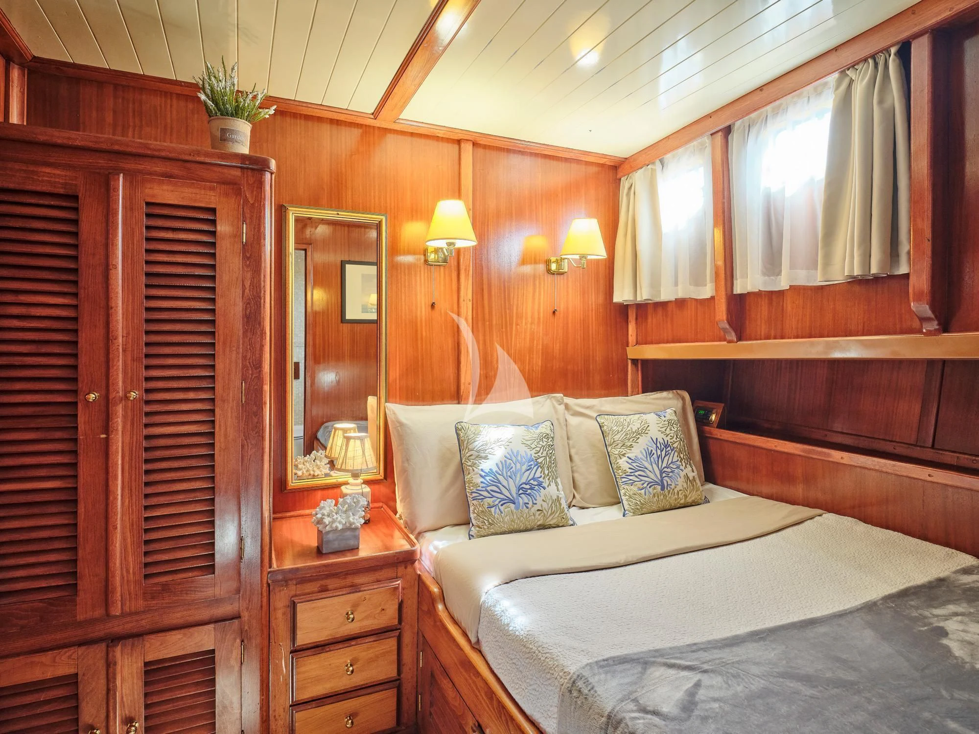 a room with a bed and a dresser aboard MYRA Yacht for Sale