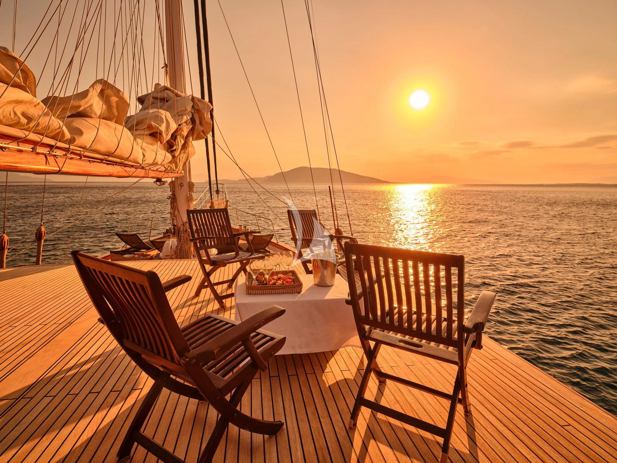 a deck with chairs and a boat on it aboard MYRA Yacht for Sale