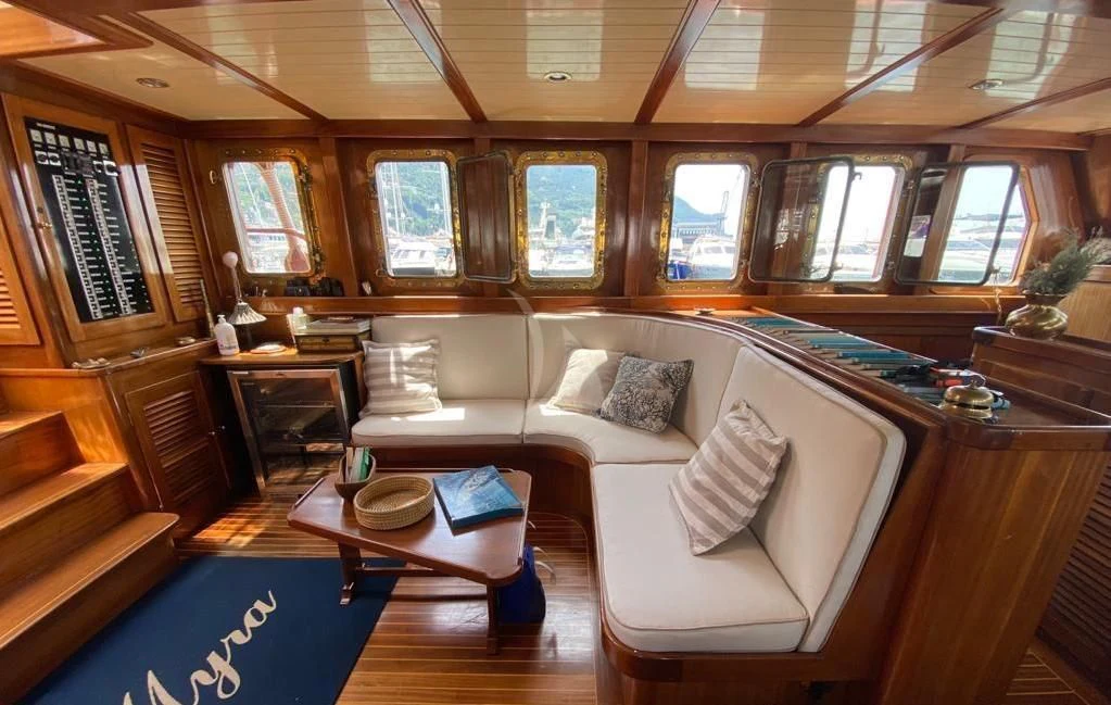 a room with a couch and a table aboard MYRA Yacht for Sale