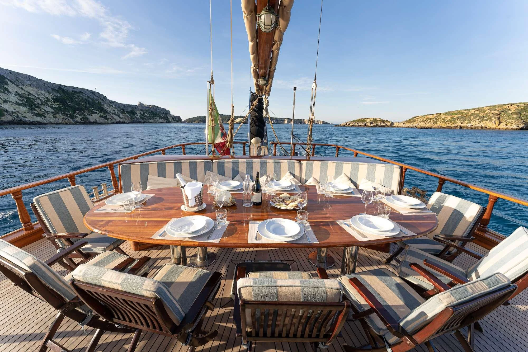 a table set for a meal on a boat aboard MYRA Yacht for Sale