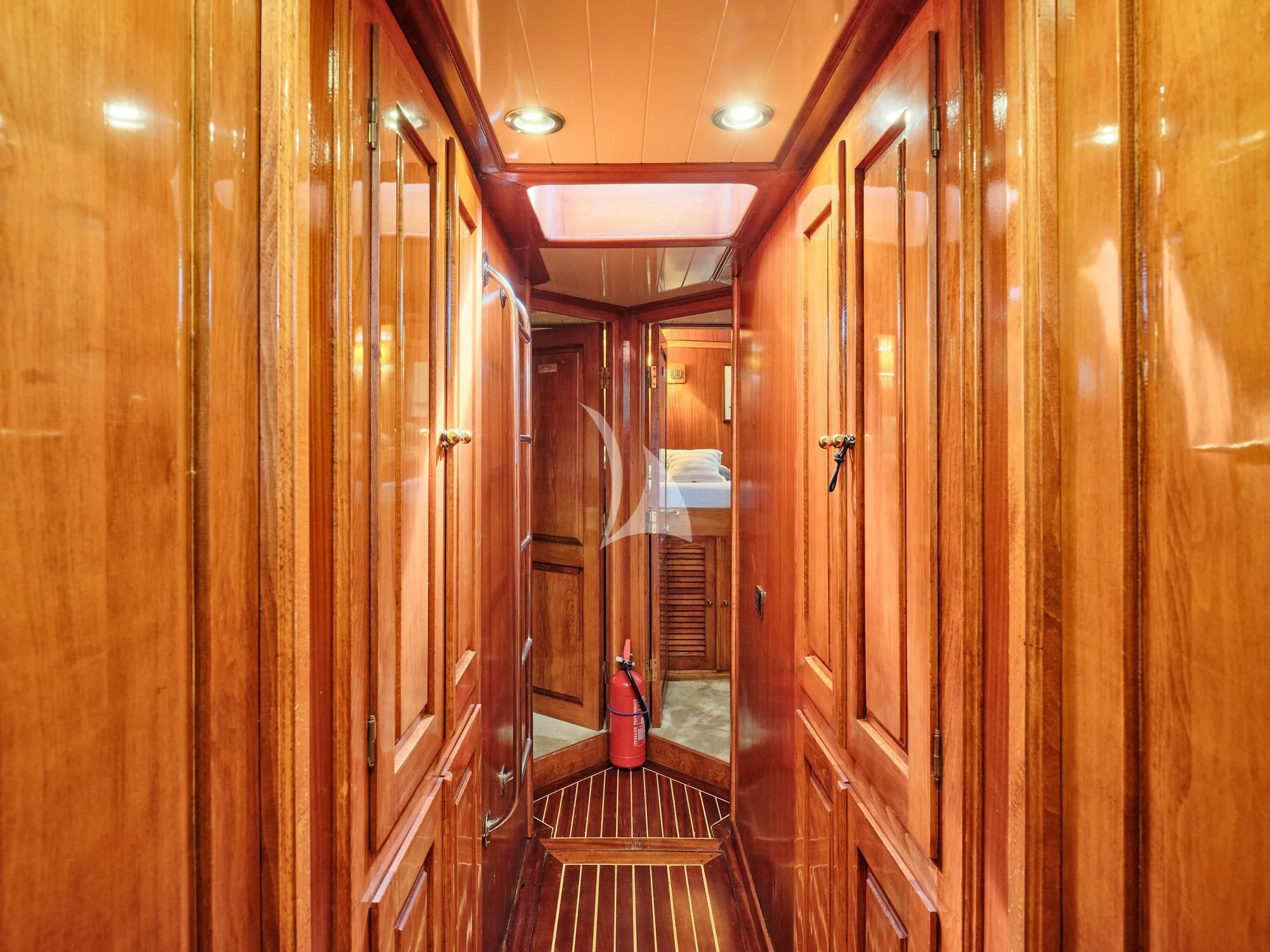 a hallway with wooden cabinets aboard MYRA Yacht for Sale