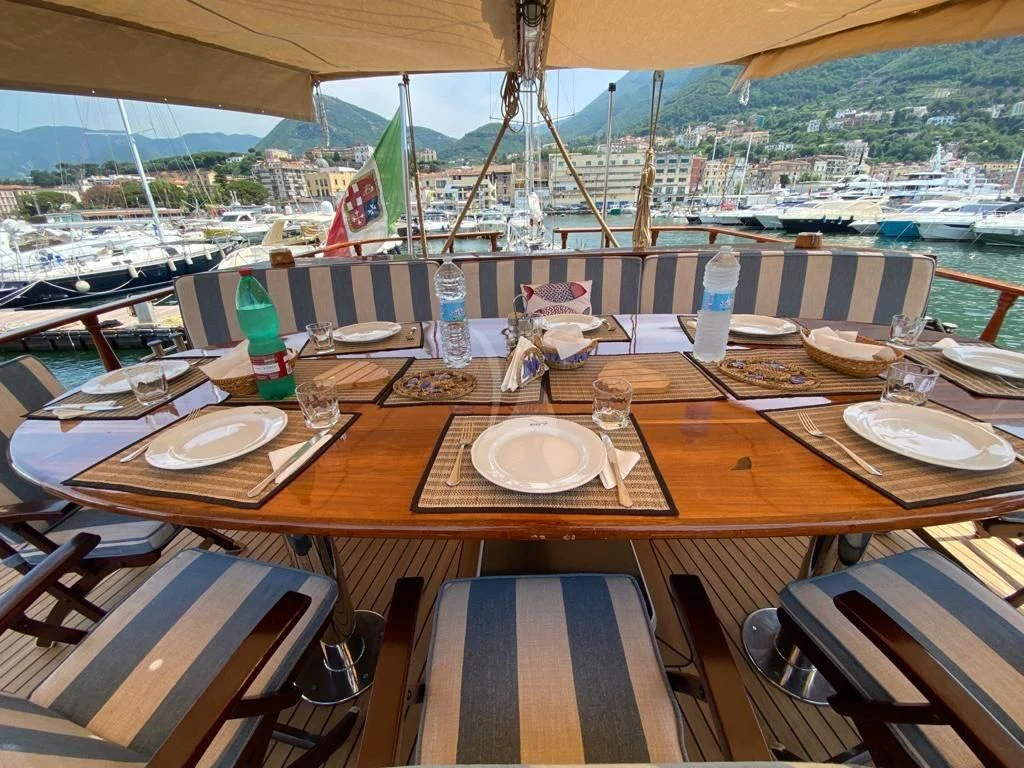 a table with plates and glasses on it aboard MYRA Yacht for Sale
