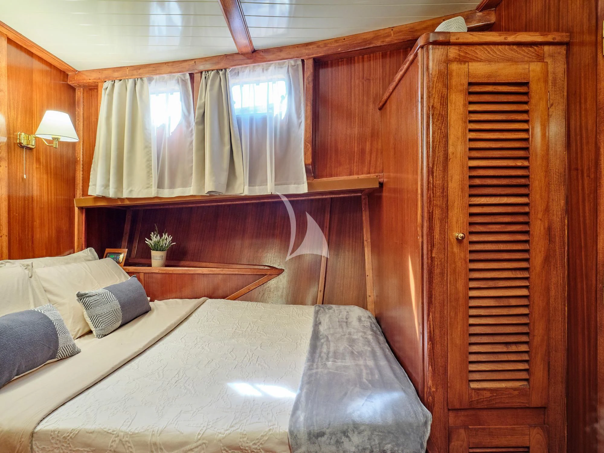 a bed with a wooden headboard aboard MYRA Yacht for Sale