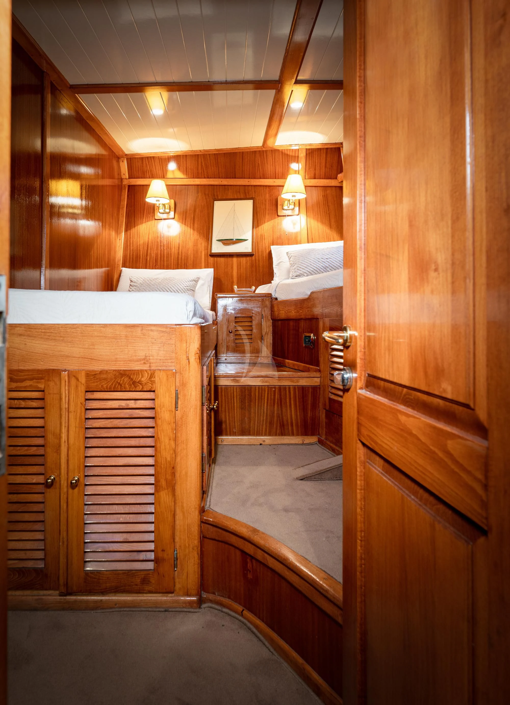 a room with a bed and a desk aboard MYRA Yacht for Sale