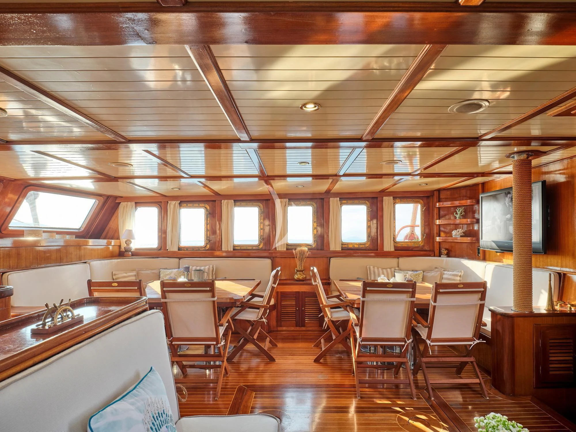 a room with tables and chairs aboard MYRA Yacht for Sale