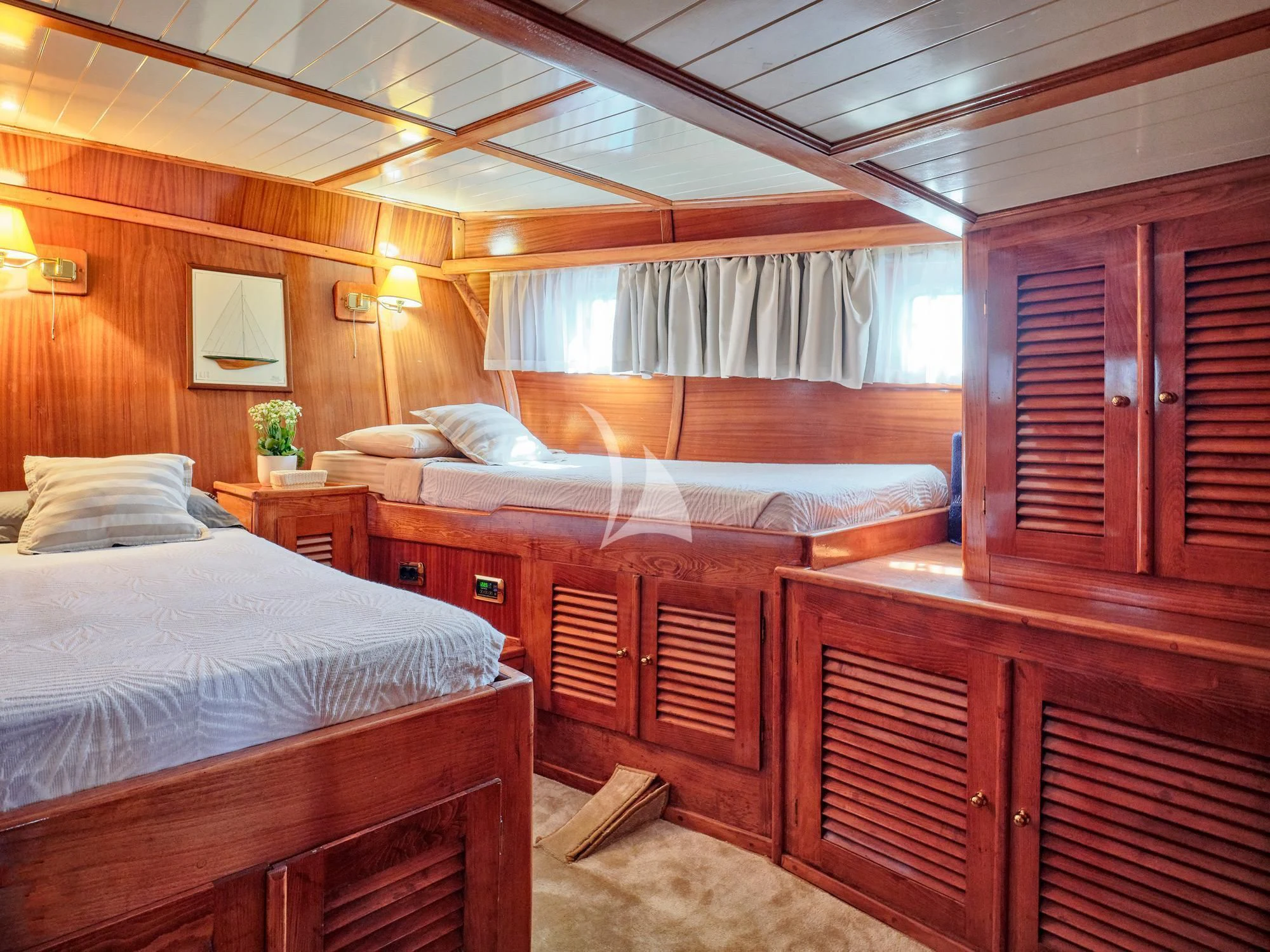 a room with wooden furniture aboard MYRA Yacht for Sale