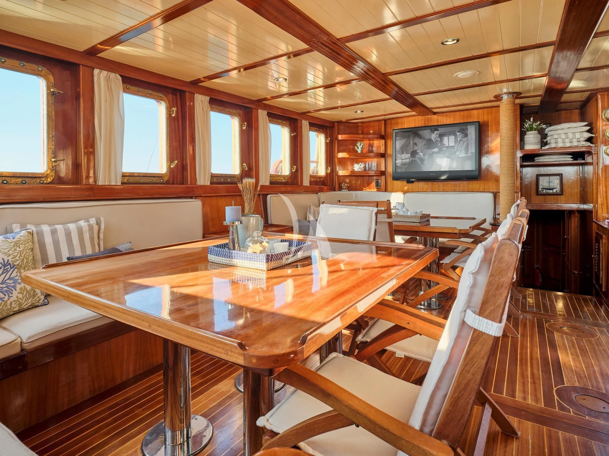 a wooden table in a cabin aboard MYRA Yacht for Sale