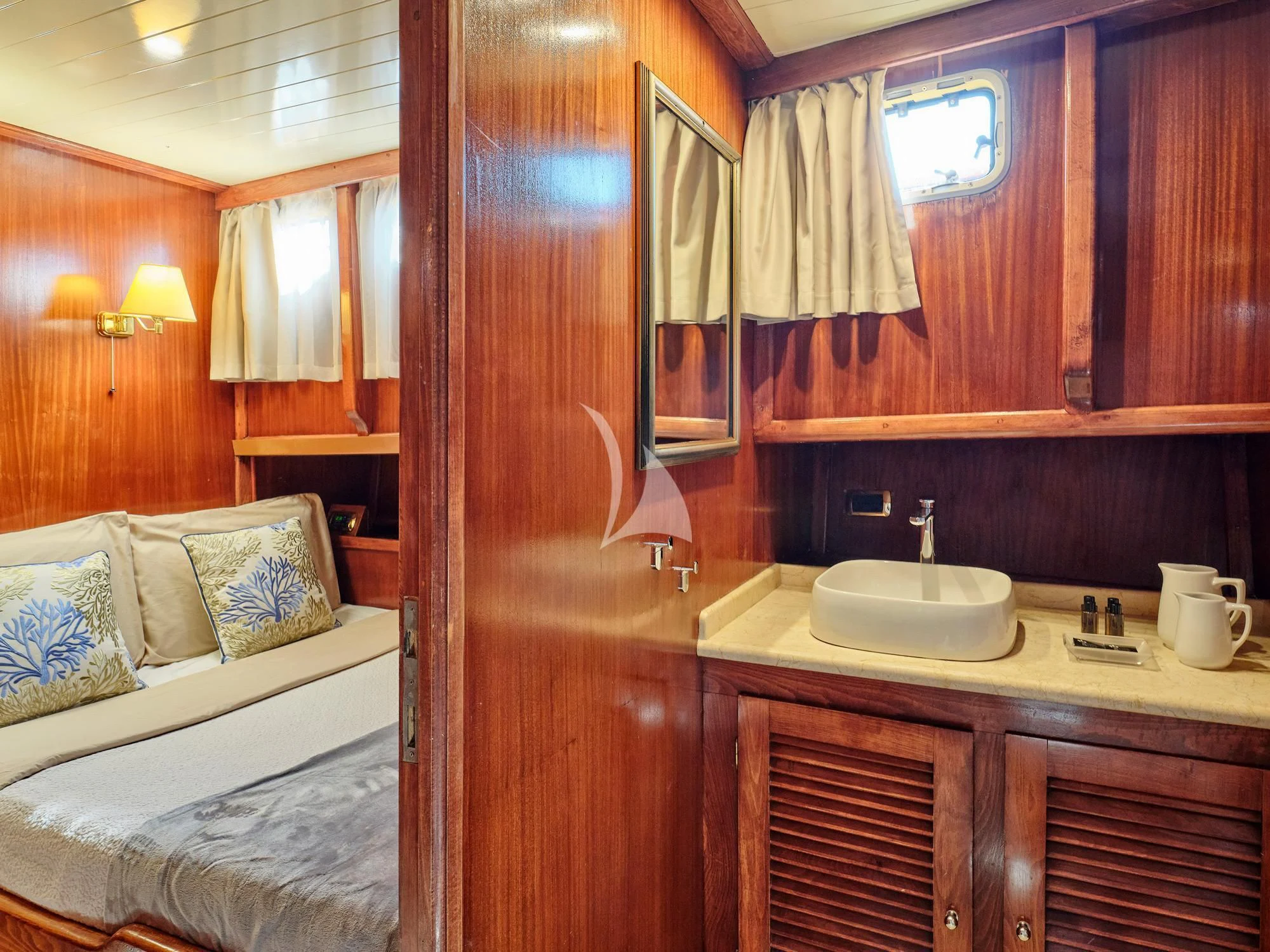 a bathroom with a sink and a bed aboard MYRA Yacht for Sale