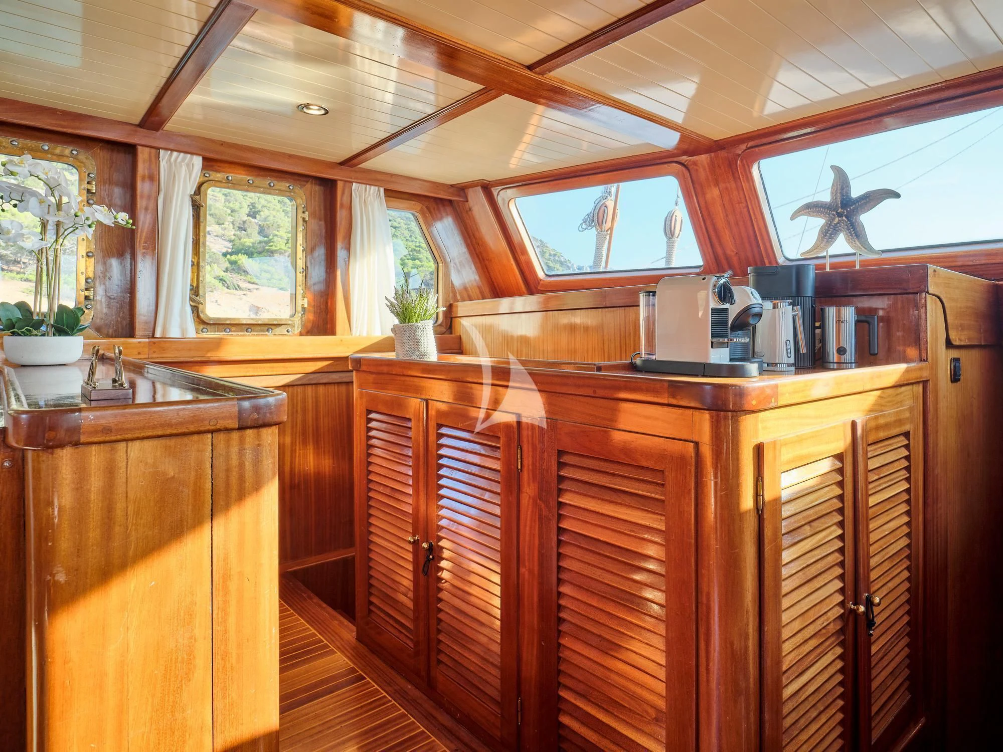 a kitchen with wooden cabinets aboard MYRA Yacht for Sale