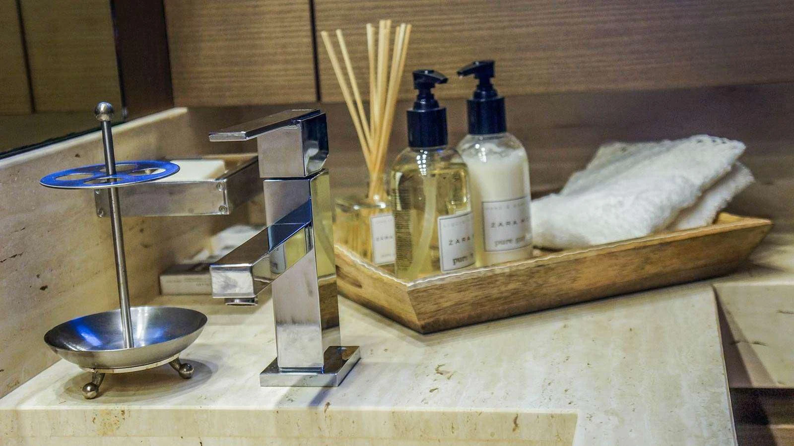 a wooden box with a sink and a couple of bottles of water aboard KUUM Yacht for Sale