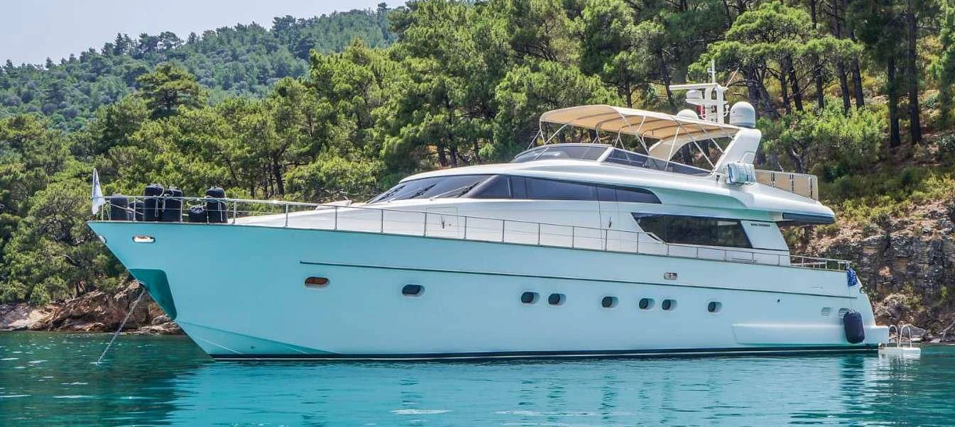 a white boat in a body of water aboard KUUM Yacht for Sale