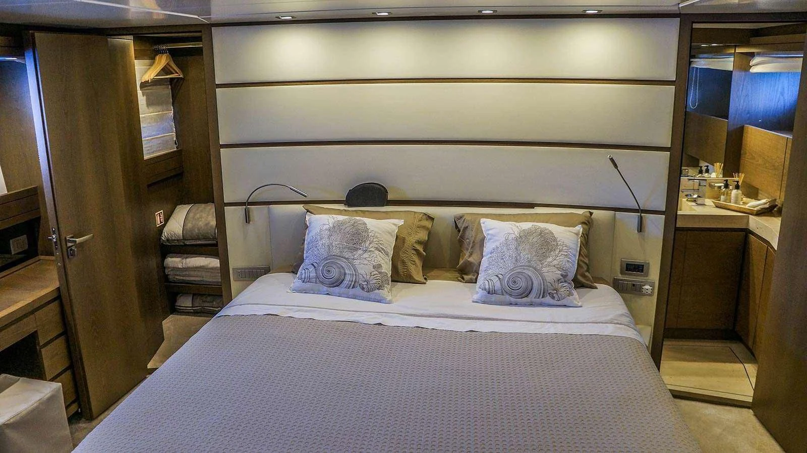a bed with a white comforter aboard KUUM Yacht for Sale