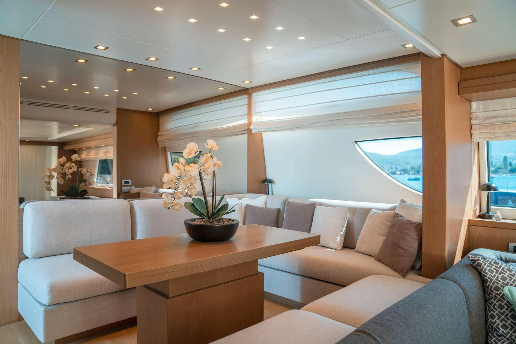 a living room with a table and couches aboard KUUM Yacht for Sale