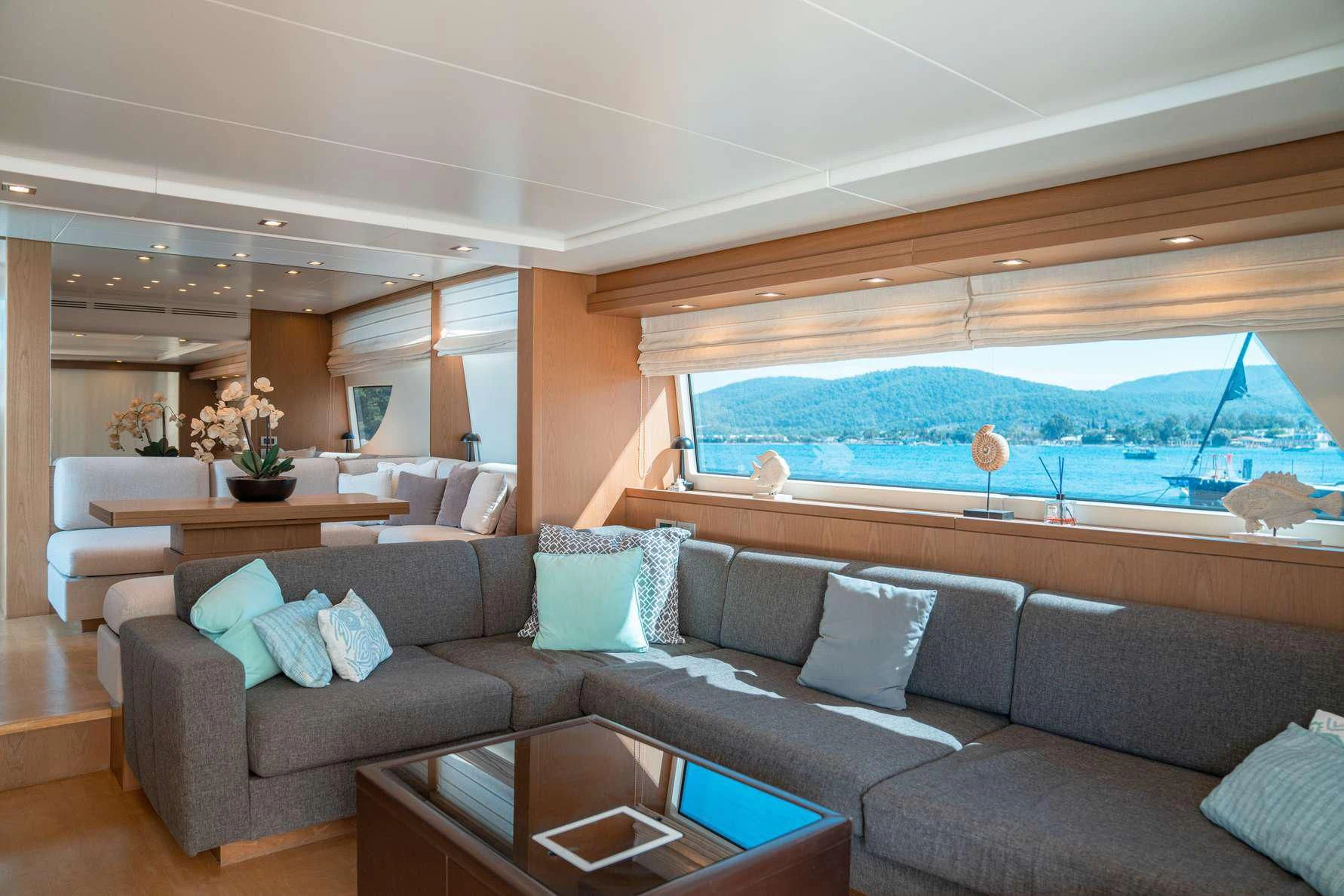 a living room with a large blue swimming pool aboard KUUM Yacht for Sale