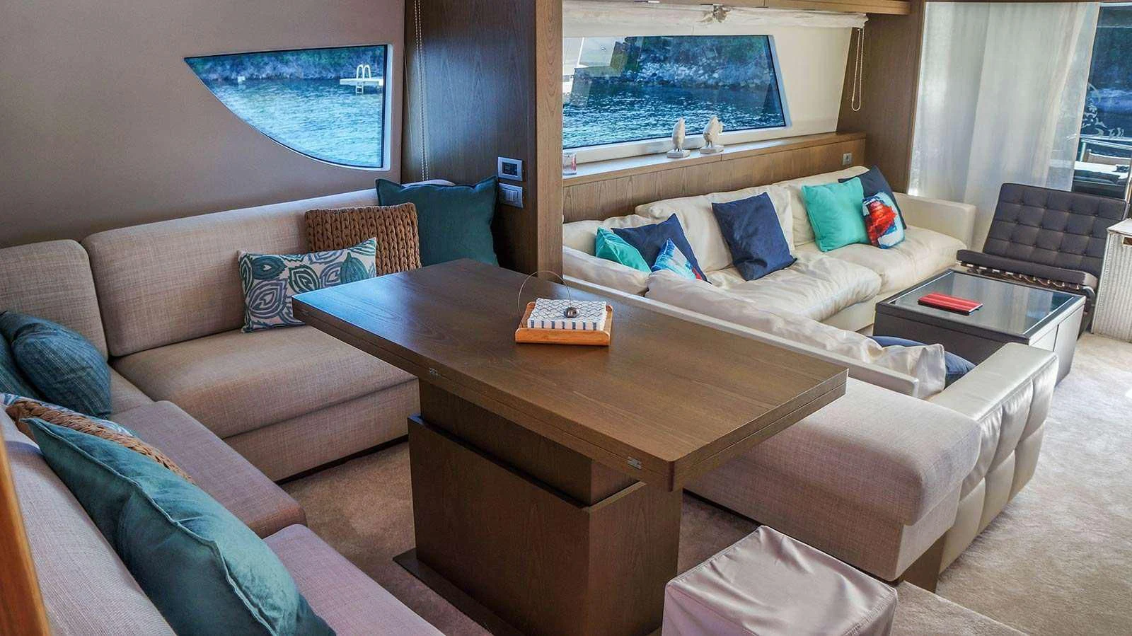 a living room with a couch and a coffee table aboard KUUM Yacht for Sale