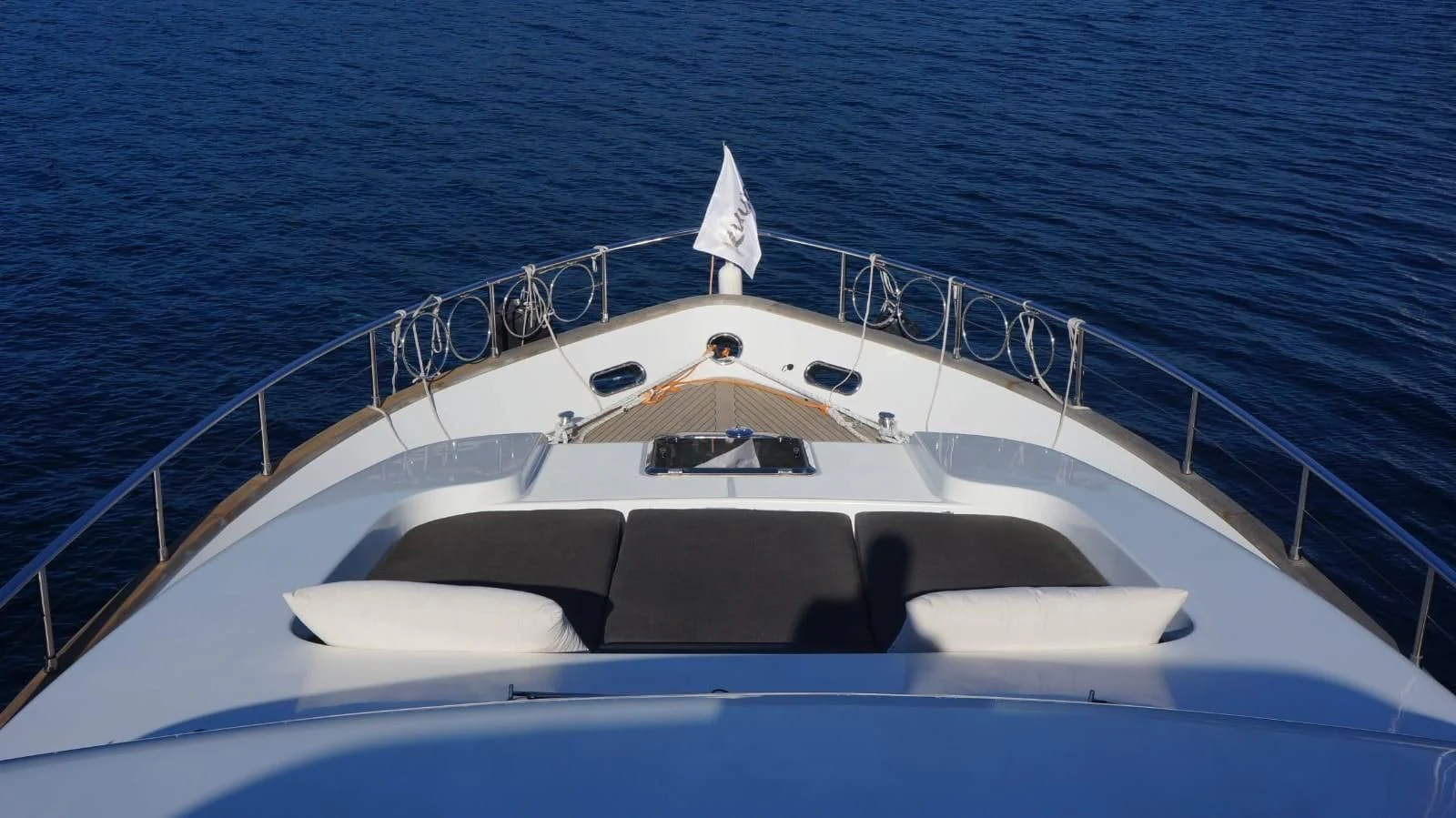 a white boat on the water aboard KUUM Yacht for Sale