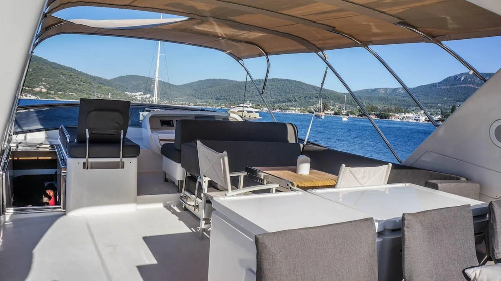 a boat with chairs and a table on the deck aboard KUUM Yacht for Sale