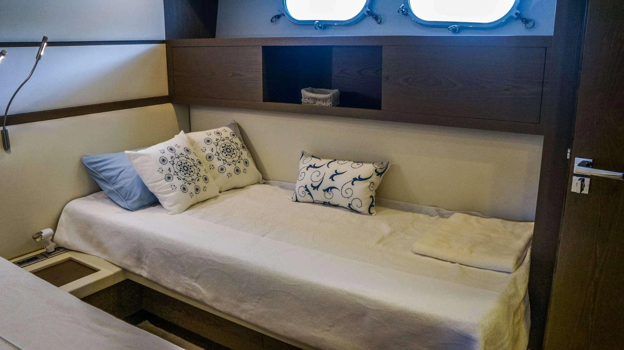 a bed with pillows aboard KUUM Yacht for Sale