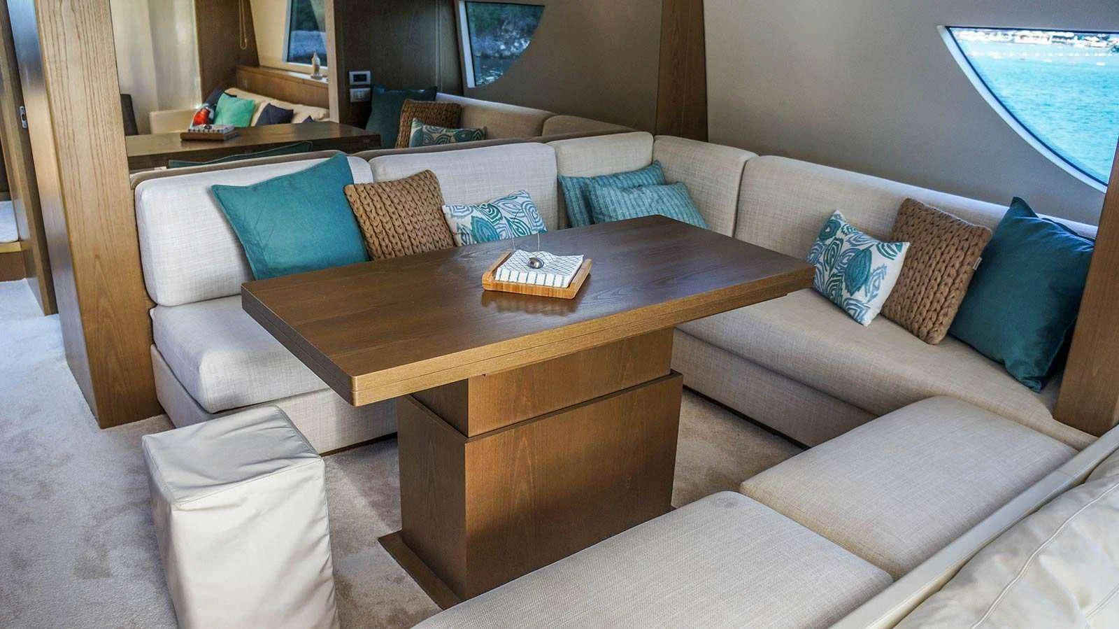 a couch with pillows and a coffee table in a room aboard KUUM Yacht for Sale