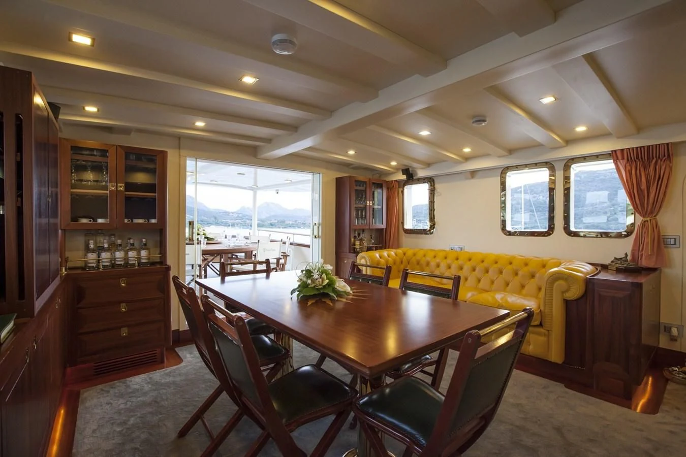 a dining room with a table and chairs aboard MARIA TERESA Yacht for Sale