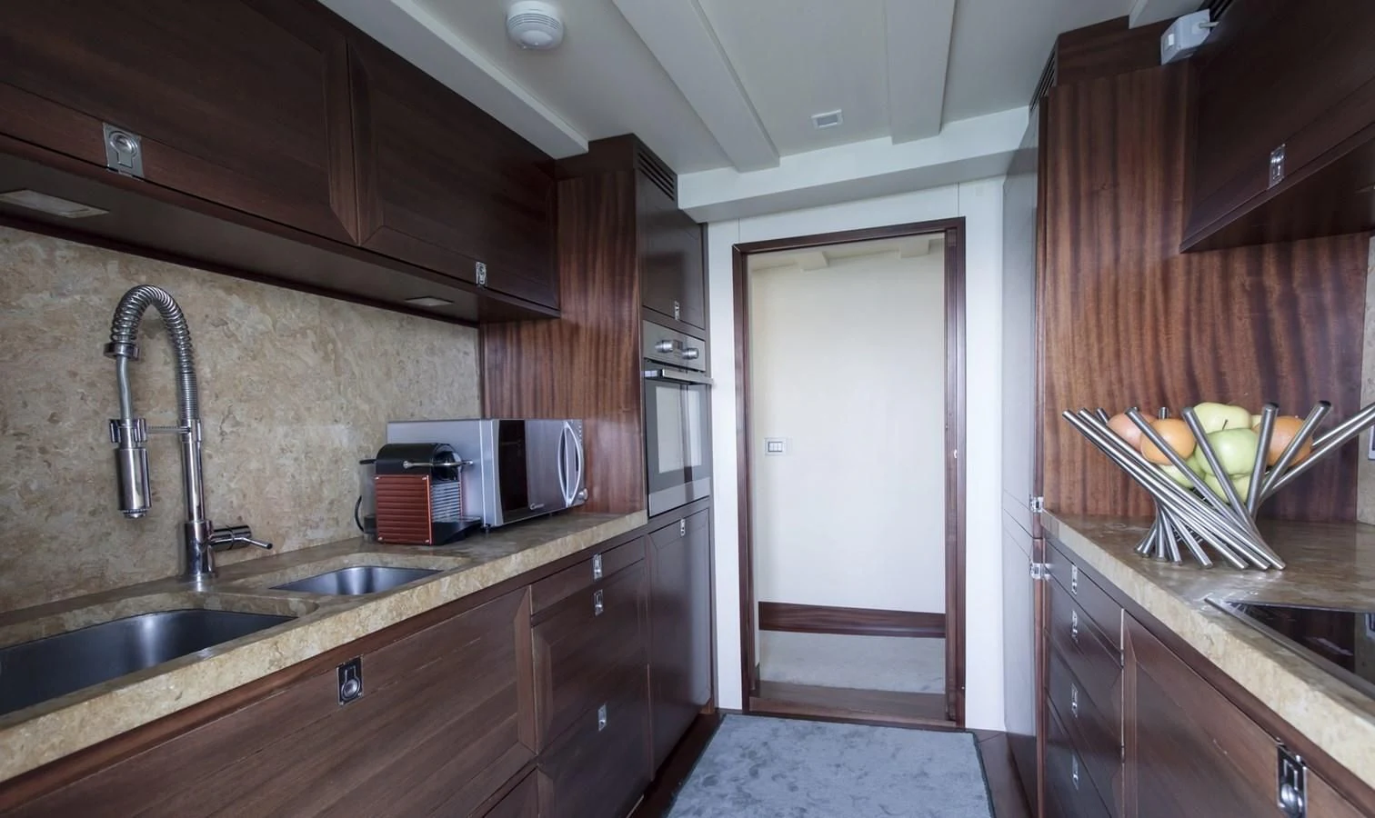 a kitchen with wooden cabinets aboard MARIA TERESA Yacht for Sale