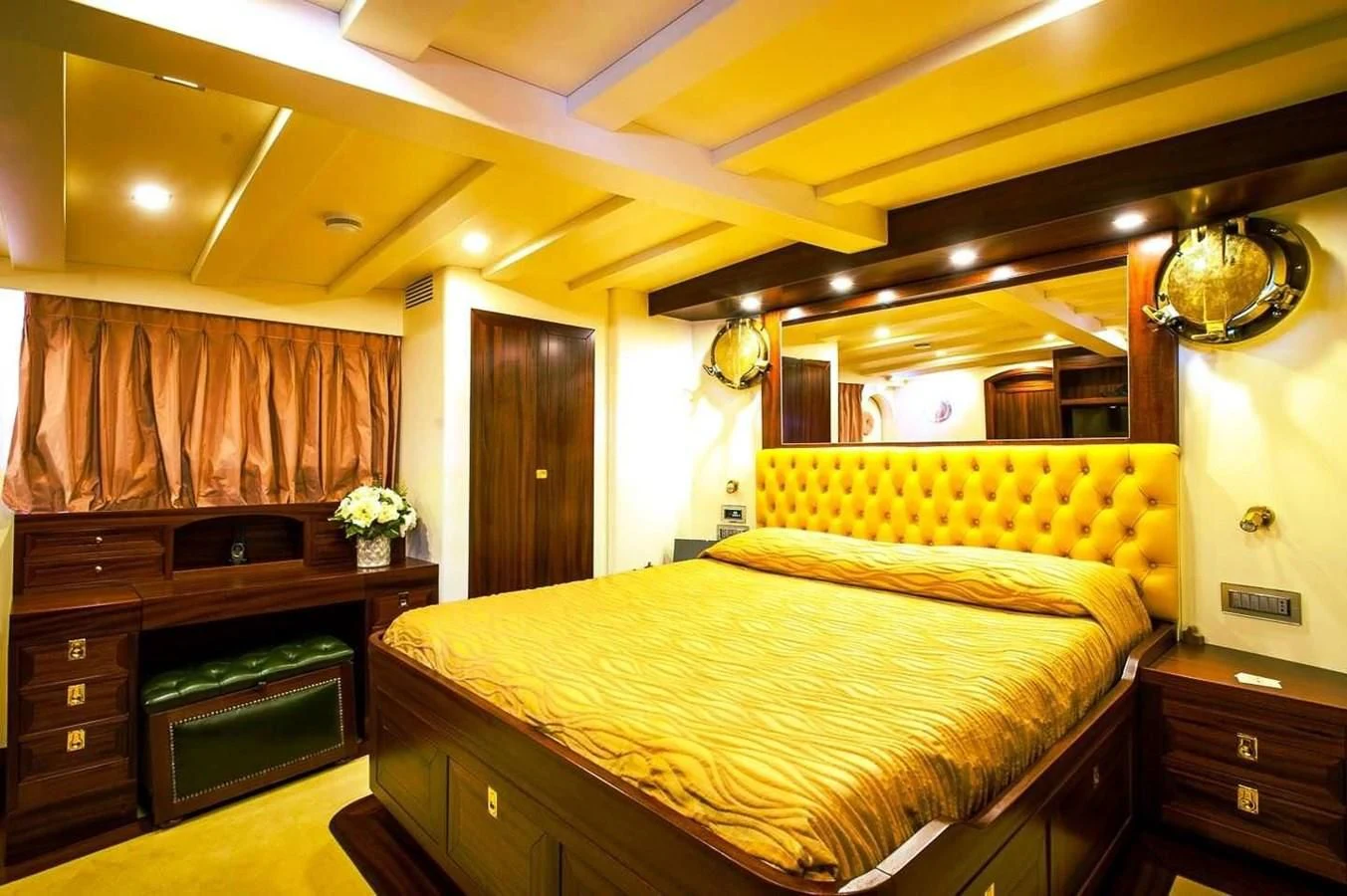 a bedroom with a bed and a dresser aboard MARIA TERESA Yacht for Sale