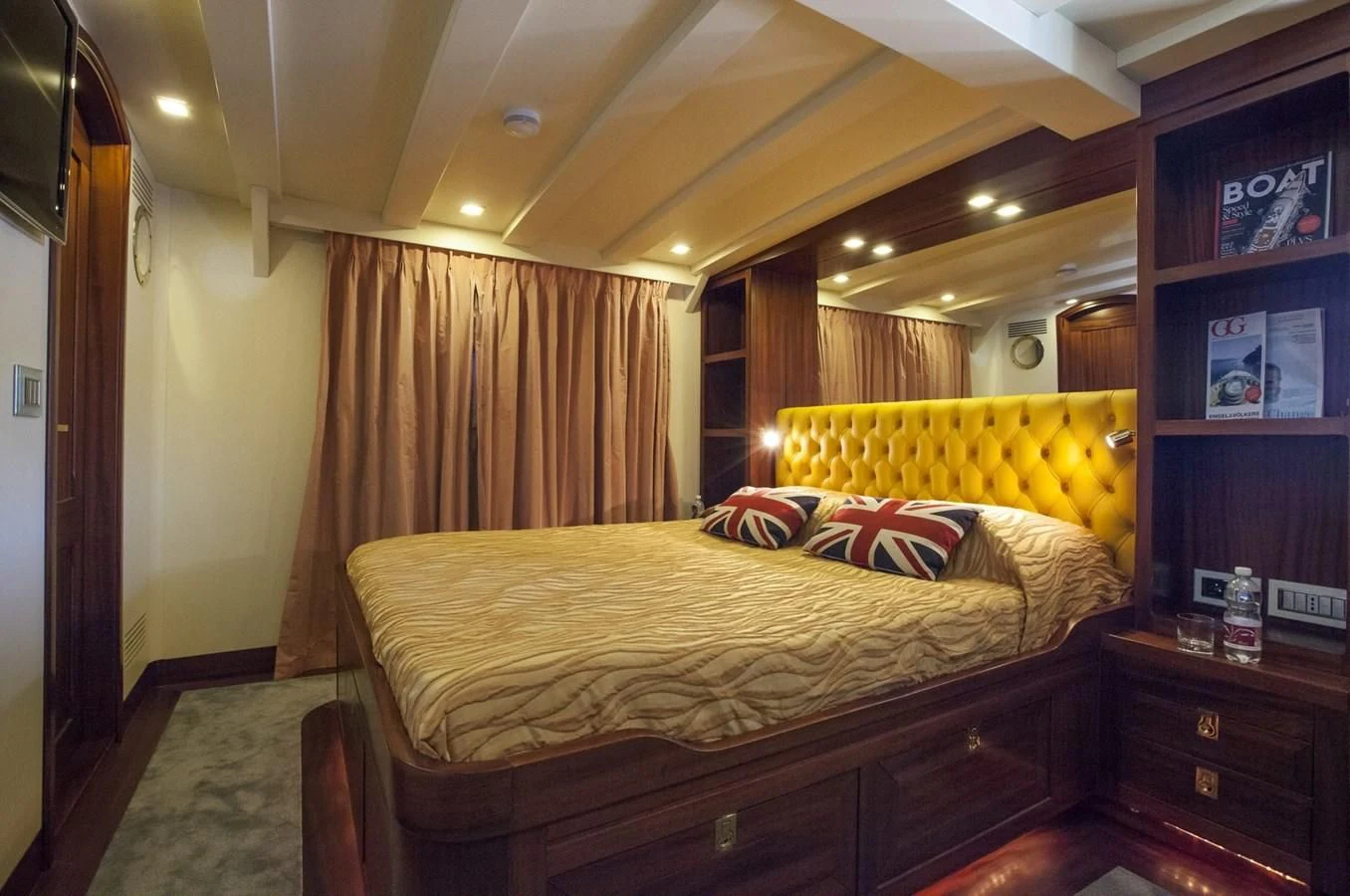 a bedroom with a bed and a bookcase aboard MARIA TERESA Yacht for Sale