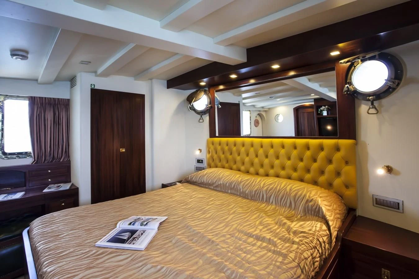 a room with a bed and a desk aboard MARIA TERESA Yacht for Sale