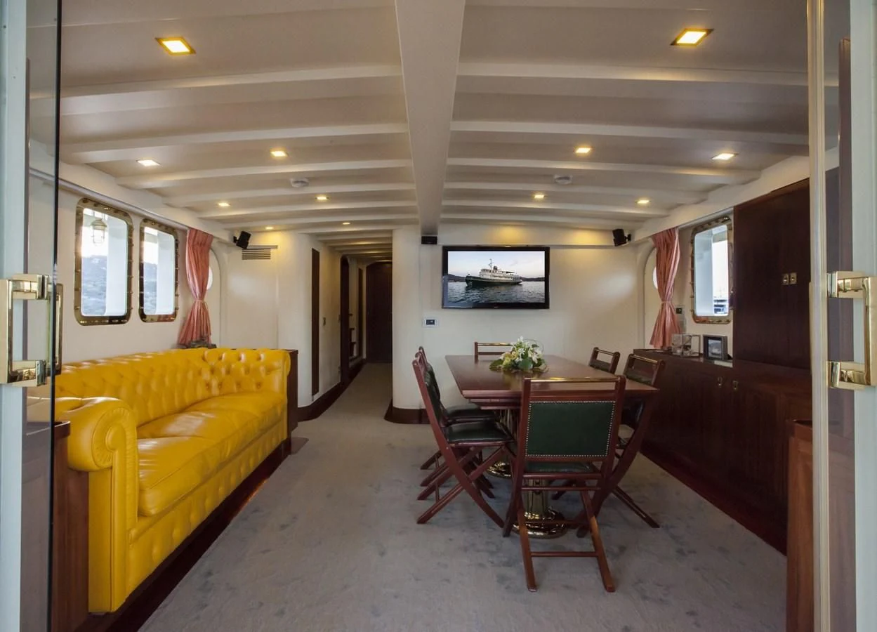 a living room with a couch and a table aboard MARIA TERESA Yacht for Sale