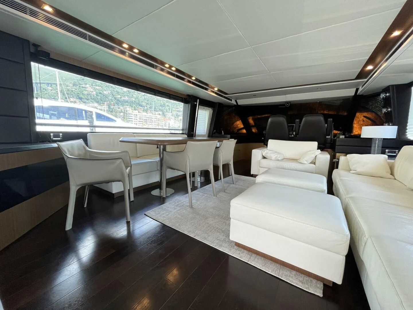 a room with a table chairs and a large window aboard CHARISMA II Yacht for Sale