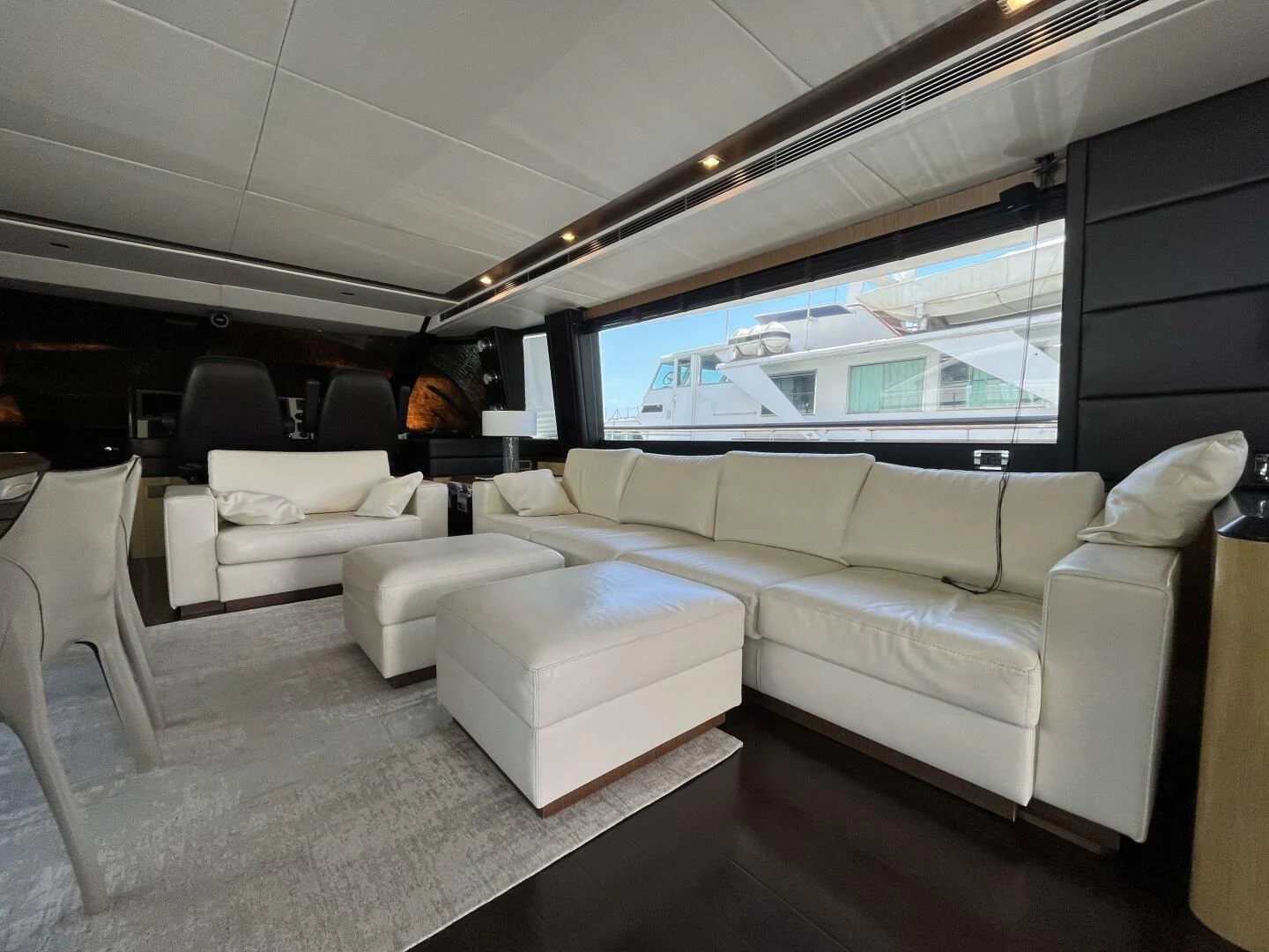 a living room with a large window aboard CHARISMA II Yacht for Sale