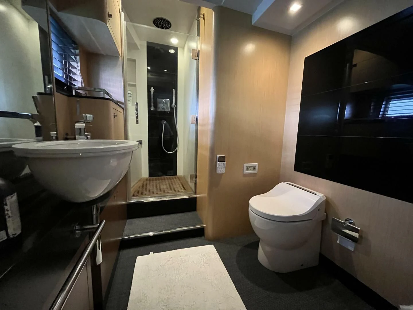 a bathroom with a toilet and sink aboard CHARISMA II Yacht for Sale