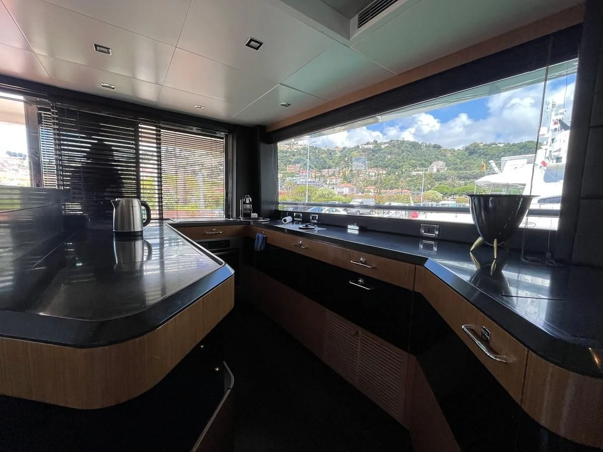 a kitchen with a large window aboard CHARISMA II Yacht for Sale