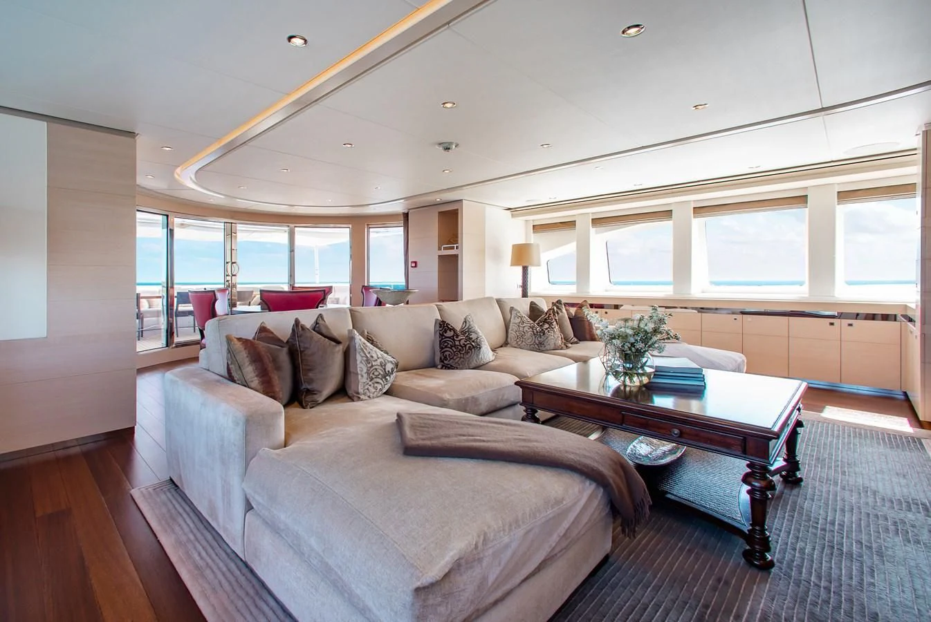 a living room with a large sofa aboard LADY L Yacht for Charter