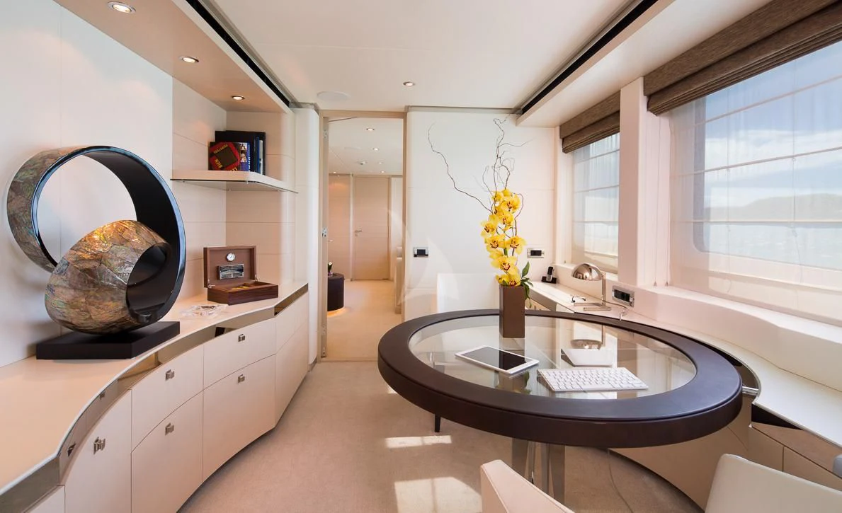 a kitchen with a round table aboard LADY L Yacht for Charter