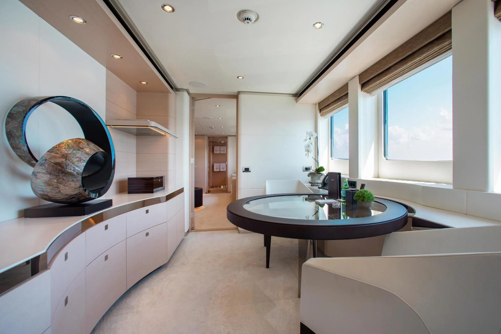 a kitchen with a large round table aboard LADY L Yacht for Charter