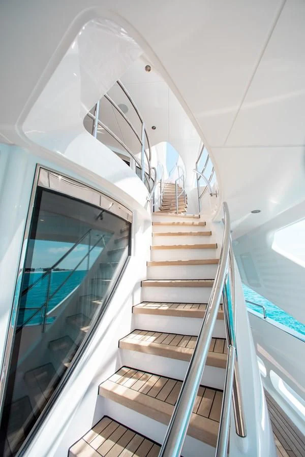 a staircase leading to a glass door aboard LADY L Yacht for Charter