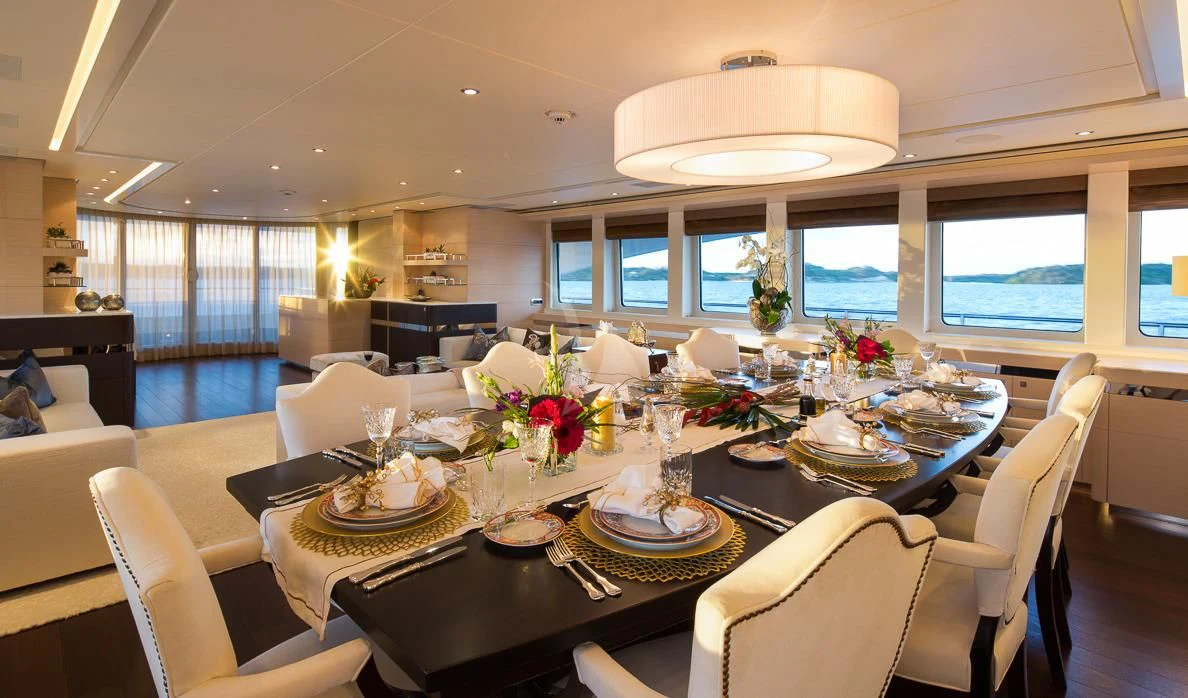 a dining room with a table set aboard LADY L Yacht for Charter