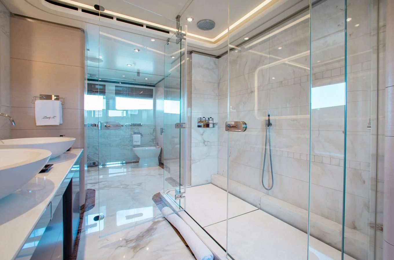 a bathroom with a glass shower aboard LADY L Yacht for Charter