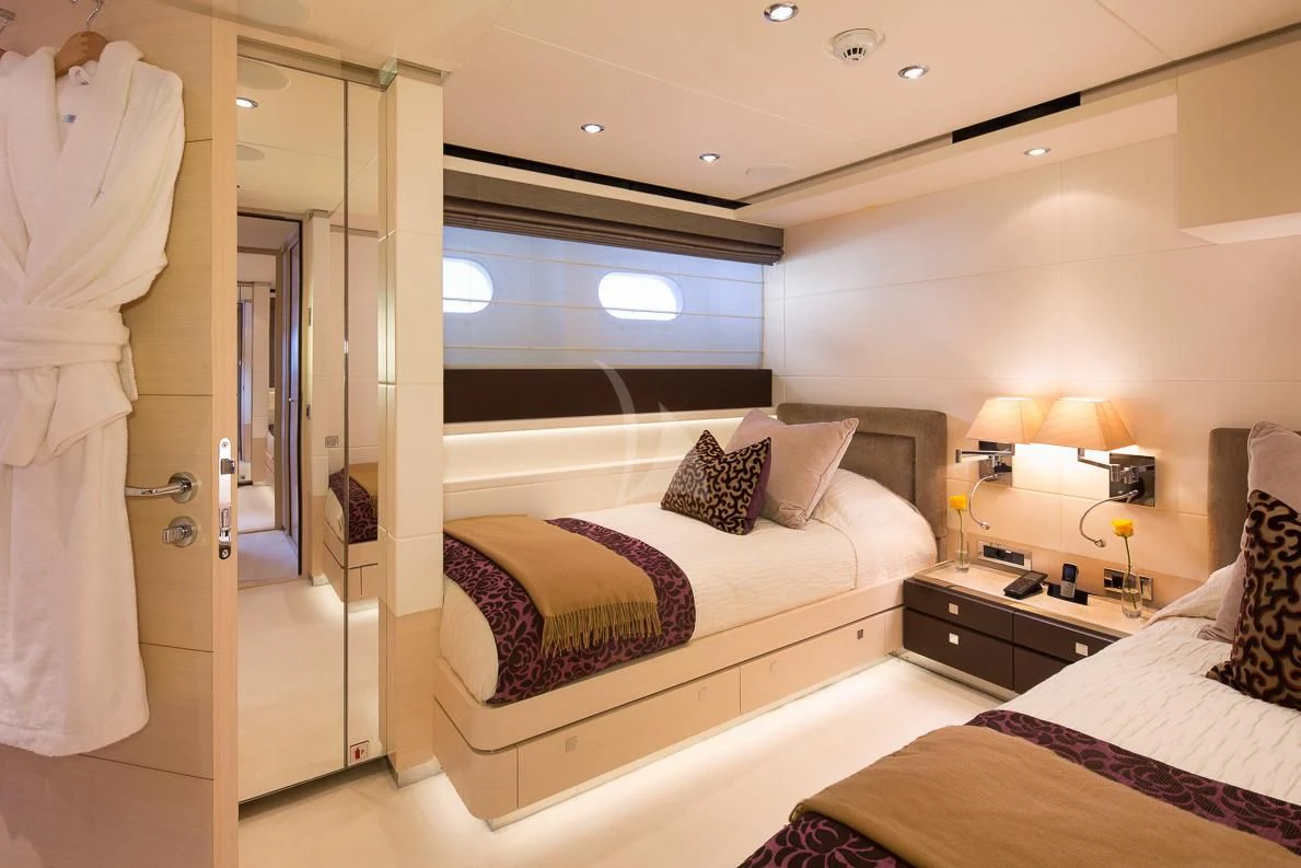 a hotel room with a bed and a large window aboard LADY L Yacht for Charter