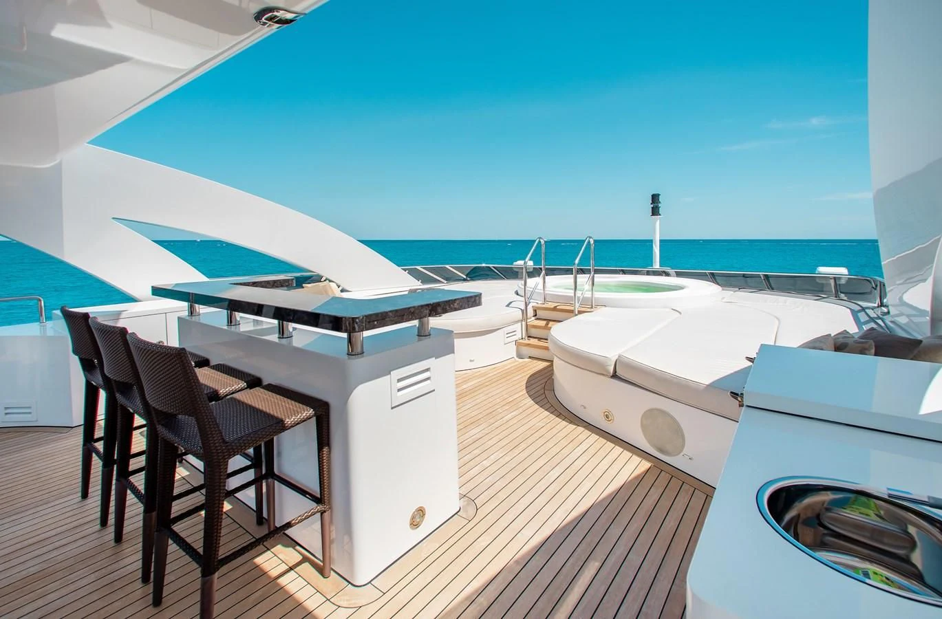 a room with a deck and chairs aboard LADY L Yacht for Charter