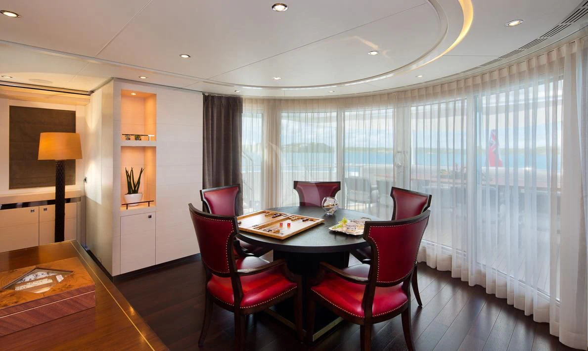 a dining room with a table and chairs aboard LADY L Yacht for Charter