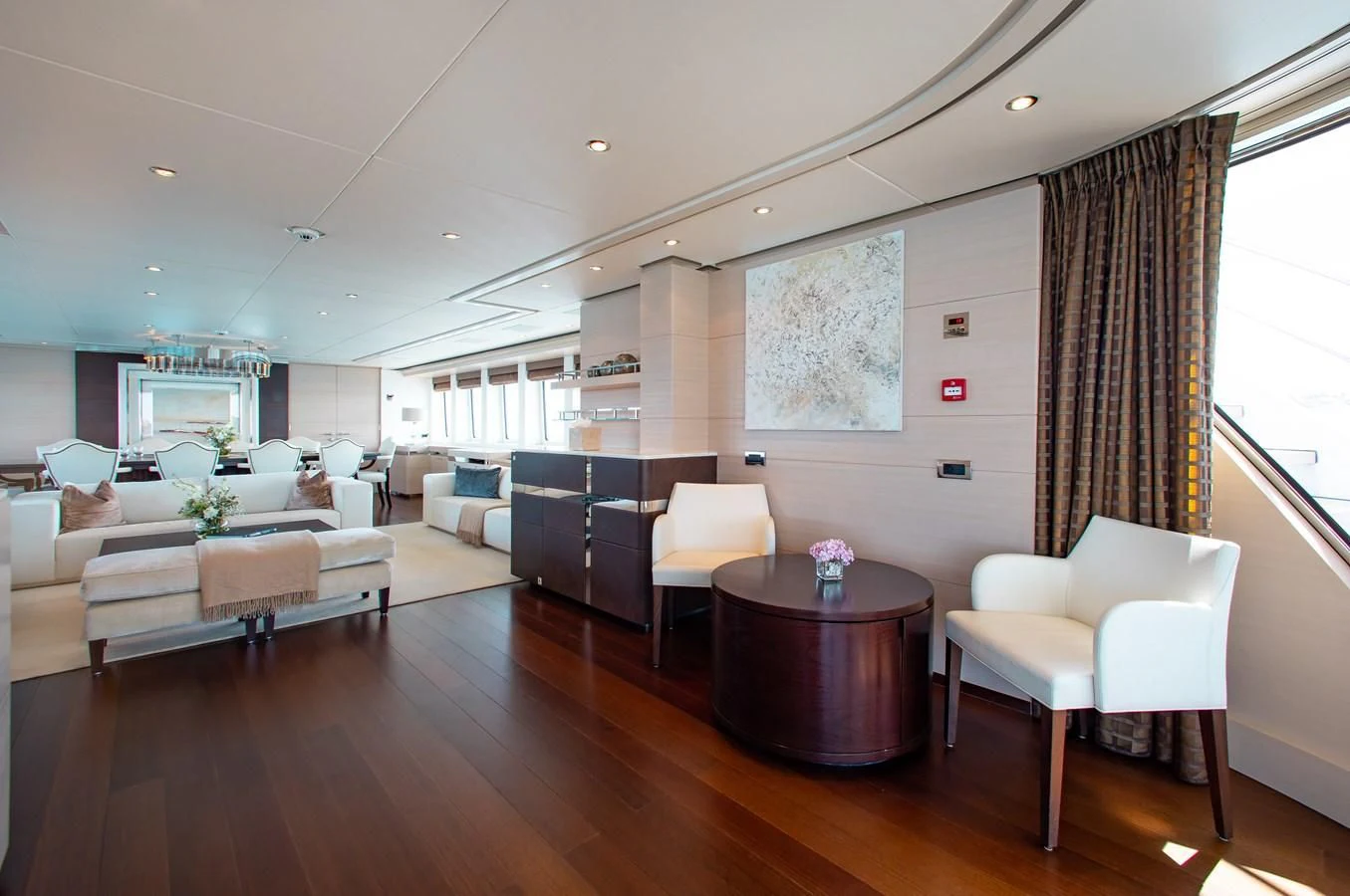 a living room with a wood floor aboard LADY L Yacht for Charter