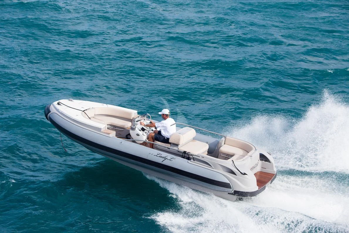 a person driving a boat aboard LADY L Yacht for Charter